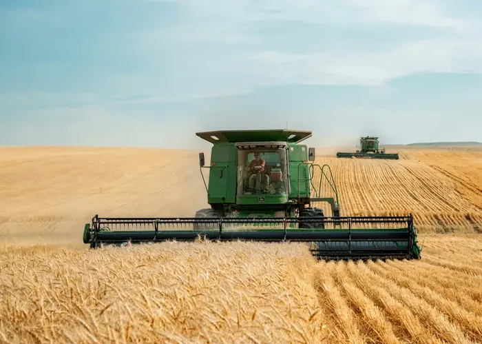 John Deere harvester in field